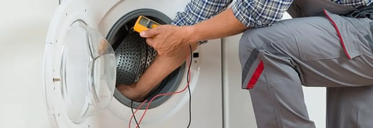 Dryer repair technician inspecting and repairing a clothes dryer in Arlington, TX