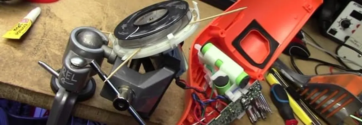 Vacuum cleaner repair parts and tools on a workbench in Arlington, TX
